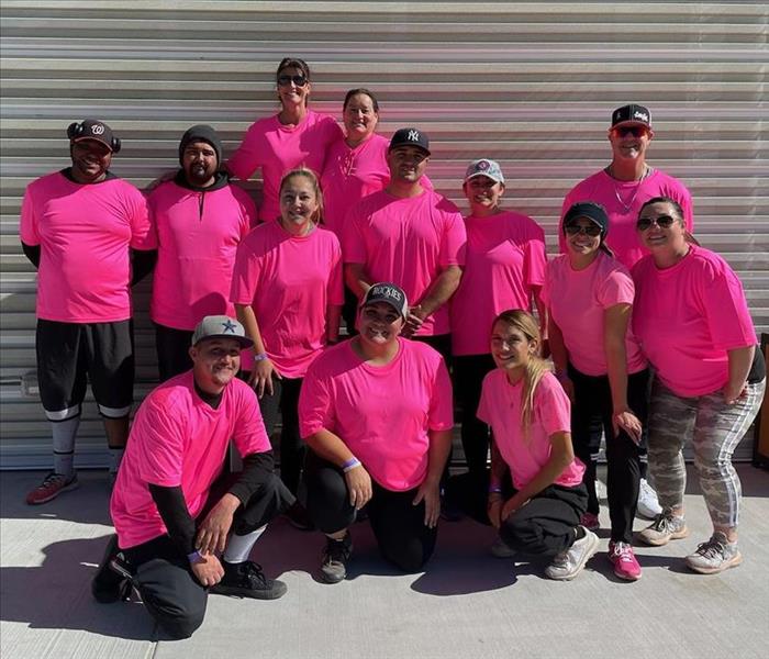 Team of Co-Eds wearing bright pink uniforms