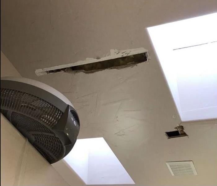 Damage to the drywall on the ceiling due to a storm